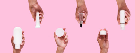 Female hands with different cosmetic products in container and bottles on pink color background.の写真素材