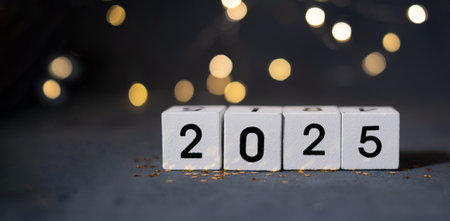 2025 New Year's wooden cubes with bokeh banner format.の写真素材