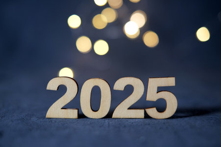 New Year 2025 in wooden numbers with bokeh.の写真素材