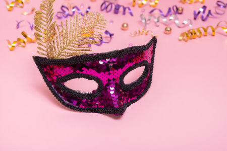 Festive face mask for carnival celebration on colored backgroundの写真素材