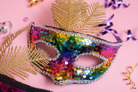 Festive face mask for carnival celebration on colored background top viewの写真素材
