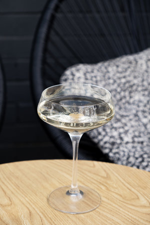 Dry sparkling white wine in glass on wooden tableの写真素材