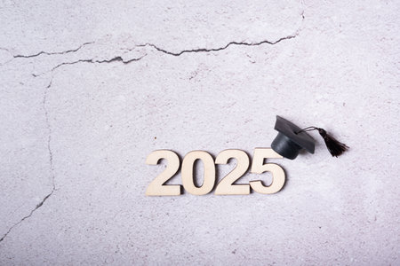 Class of 2025 concept and graduation cap on grey background