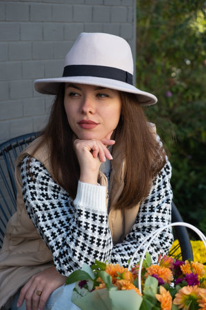 Beautiful brunette in a hat and autumn clothes.の写真素材