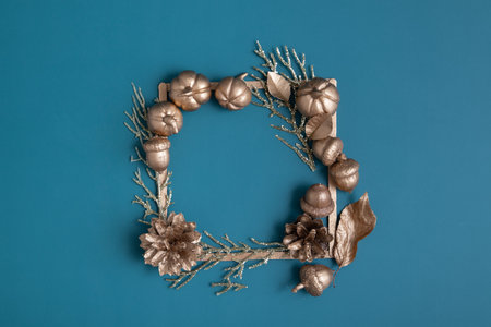 golden pumpkins and acorns with frame for text on a turquoise background. Minimalistic thanksgiving day conceptの写真素材