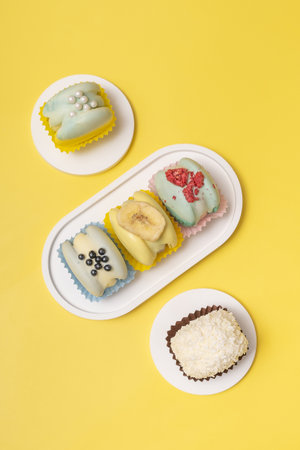 Delightful macaroons presented on podiums against yellow backdrop.