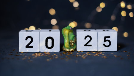 2025 New Year wooden cubes with green snake and bokehの写真素材