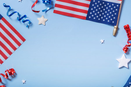 Festive decorations for USA Independence Day with flags, stars and ribbons on blue backdropの写真素材
