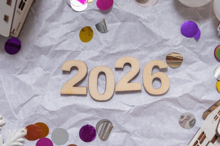 Decorative elements surround the year 2026, showcasing a festive atmosphere filled with vibrant...