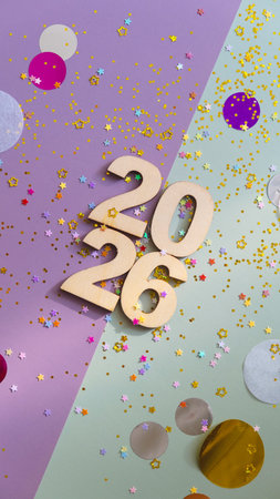 Wooden numbers 2026 on colourful surface with star glitterの写真素材
