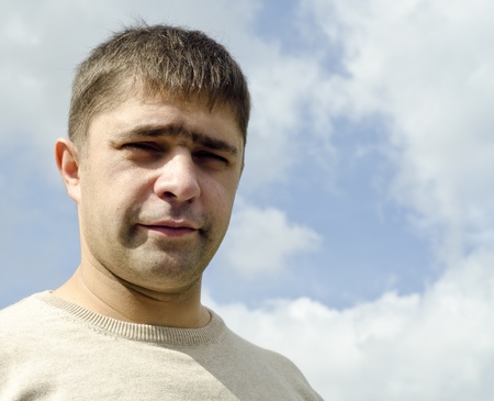 Image of young man with sky behind him