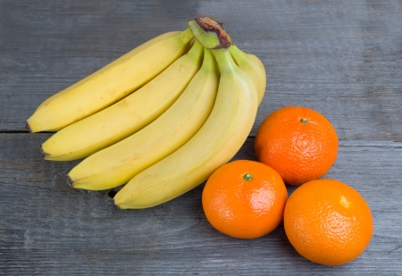 Image of bananas and oranges on wooden backgroundの写真素材
