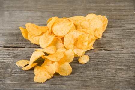 Image of crunchy potato chips on wooden backgroundの写真素材