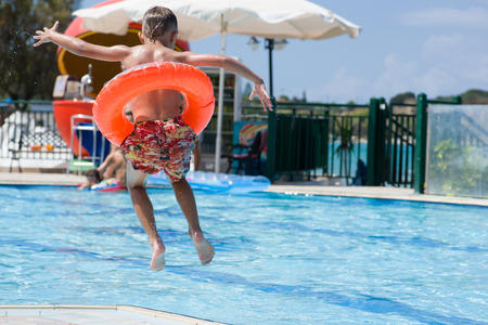 Image of Boy jumping to the poolの写真素材