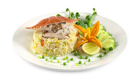 Fried rice with Crab decorate with vegetables carved Chinese and Thai food fusion style popular menu in Thailand side view isolated on white backgroundの写真素材