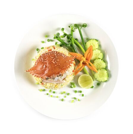 Fried rice with Crab decorate with vegetables carved Chinese and Thai food fusion style popular menu in Thailand top view isolated on white backgroundの写真素材