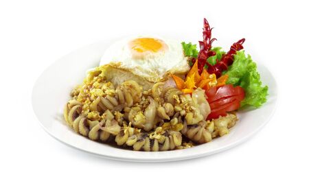 Squid tentacles Stir fried garlic and pepper with rice and fried egg decorate with carved chili fusion Thai food spicy dish side viewの写真素材