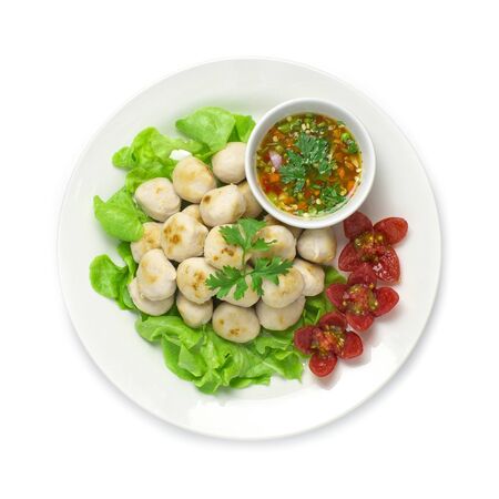 Pork Ball grilled and spicy deepping sauce Thai food appetizer style spicy tasty popular in Thailand street food decorate with tomato and vegetable top viewの写真素材