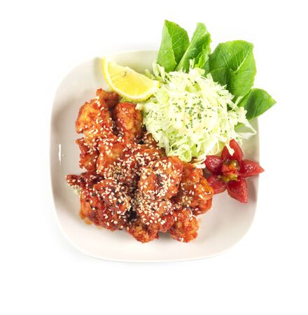Bonchon Fried Chicken Korean style decorate tomato, lemon, vegetables cabbage top viewの写真素材