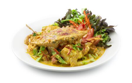 Stir fried Blue Crab with Salt Egg Yolks Sauce Thai Food fusion style decorate carved chili peppers and spring onion and Green oak salad vegetables side viewの写真素材