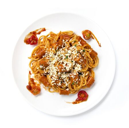 Spaghetti Bolognese with saucesage in tomato sauce topped chopped leaf basil and cheese sprinkle fusion food Italian traditional style decorate with carved tomato cherry top viewの写真素材