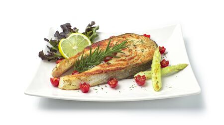 Salmon Steak with black  peppers and salt healthy diet food decorate with small cherry tomato and grill white asparagus side viewの写真素材