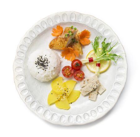 Breakfast set with rice on top black sesame ,side dish with pickled radish,pea sprouts, mushrooms tofu salad in sesame sauce and tomato carved,fusion food Japan style for healthy and diet foodの写真素材