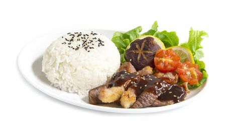 Grill Beef barbecue sauce with rice fusion food Japan style decorate with salad shitake mushrooms and tomato carved  side view  isolated on white backgroundの写真素材