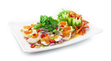 Spicy Salt Eggs Salad with vegetable Hot Spicy Tasty Thai Food fusion style decorate carved cucumber, chili peppers and spring onion side viewの写真素材