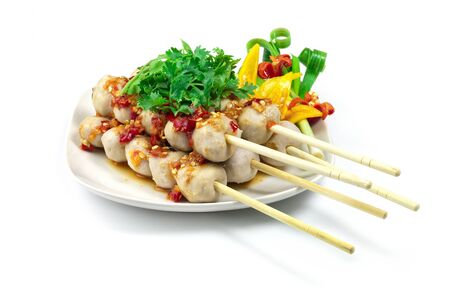 Pork Ball Grilled with bamboo sticks serving on top with seafood spicy sauce dipping and coriander vegetables Thai food appetizer spicy Thai style side viewの写真素材
