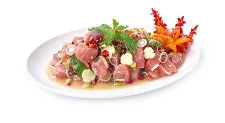 Spicy Salmon Salad in Thai herbs sauce Thai spicy food appetizer the popular of Thailand decorate with carved chili goodtasty and healthyfood for diet side viewの写真素材