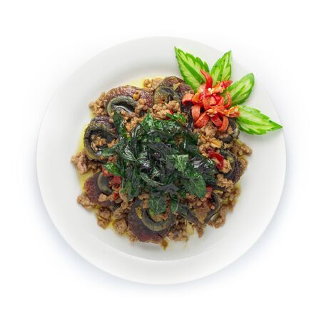 Thai Food Stir-fried Preserves Eggs,Century Egg with Pork hot Spicy with Thai Basil served on top Crispy Thai Basil decorate carved chili and cucumber top viewの写真素材
