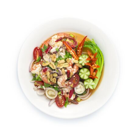 Spicy Salad Squids with Shrimp Seafood ingredient and Minced Pork, vegetable, Hot Spicy Tasty Thai Food fusion style decorate carved cucumber, chili peppers and spring onion top viewの写真素材