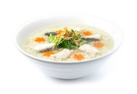 Rice Porridge boiled with Asian Seabass fish Cutlet cooking tasty Main Course Thai food fusion style decorate mix Chinese food style decorate with carved carrots and vegetable cutlet side viewの写真素材