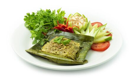 Thai Food Northern Style Grilled Minced Pork Spicy  curry chili decorate with vegetables carved Cucumber, eggplants, chili and coriander Thai herbs side viewの写真素材