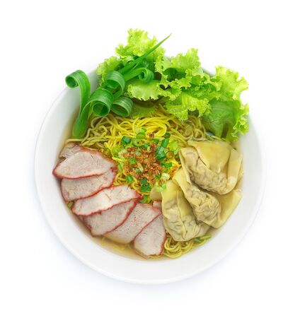 Egg Noodles with Red roast Pork and Wonton Dumplings on top Crispy Garlic and Spring Onions on bowl with soup top viewの写真素材