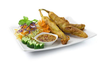 Deep Fried Crispy Chili Peppers Stuffed with Minced Pork Served Sweet Chili Peanut Sauce Asian Food Thai Style decorate with carved carrots and Slice Cabbage side viewの写真素材