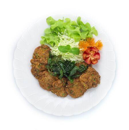 Thai Fish Cake Paste chili deep fried with herb and Crispy Thai Basil. Thai Food dish style decorate with carved carrots flower shape and tomato top viewの写真素材
