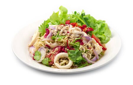 Spicy Salad Instant Noodles with Squids and Minced Pork, vegetable, Hot Spicy Tasty Thai Food fusion style decorate carved cucumber, chili peppers and spring onion side viewの写真素材