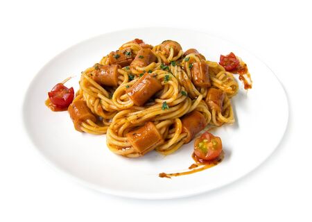 Spaghetti Bolognese with sausage in tomato sauce topped chopped leaf basil sprinkle fusion food Italian traditional style decorate with carved tomato cherry side viewの写真素材