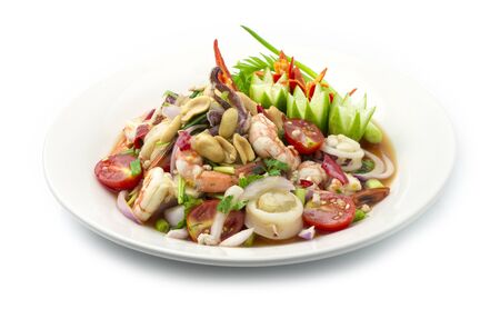 Spicy Salad Squids with Shrimp Seafood ingredient and Minced Pork, vegetable, Hot Spicy Tasty Thai Food fusion style decorate carved cucumber, chili peppers and spring onion side viewの写真素材