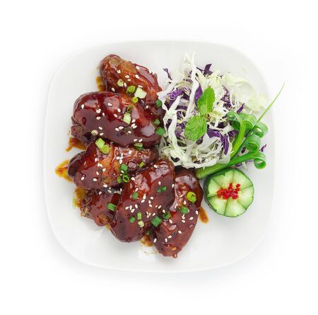 Spicy Korean Fried Chicken Bonchon Sauce Korean Style Topped Ssesame and Spring onions decorate with carved cucumber and Slice Cabbage style topviewの写真素材