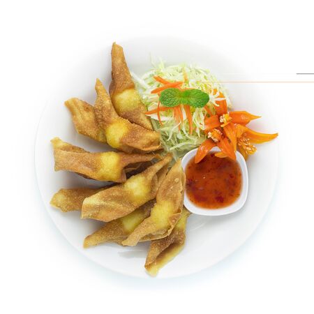Crispy Wonton with Quail Egg Stuffed inside Served Sweet Chili dipping Sauce Appetizer Thai food Mix Chinese Food Asian style decorate with carved Chili peppers, vegetables top viewの写真素材