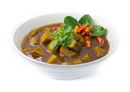 Thai Fish Organs Sour Curry Soup with Long Bean,Bamboo shoot,eggplants cutlet Thai food Southern style decorate with Kaffer lime leaf and chili carved side viewの写真素材