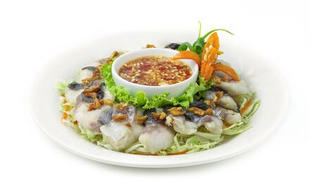 Steamed Pangasius Fish Blanching (Fresh Sea Dolly  Fish Boiled) Topped Crispy Garlic Served with Spicy Seafood sauce Thai Food Style goodtasty decorate with vegetables and carved Carrot flower shape side viewの写真素材