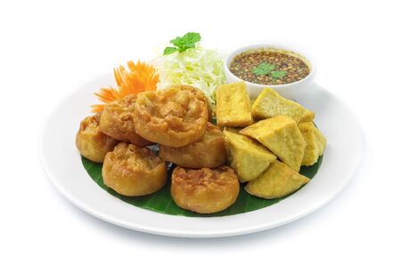Fried Taro Cake Vegetarian (Zhu Jiao Quan)and Fried Tofu Mixed Dish Served with sweet chili Dipping Sauce mix Peanut chopped Appetizer dish , Break Time Chinese Food and Thai Food Fusion Style side viewの写真素材