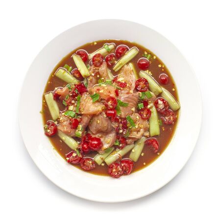 Spicy Salmon Salad with Lotus Stem in pickled fish sauce Thai spicy food appetizer the popular of Thailand decorate with carved cherry tomato goodtasty and food for diet top viewの写真素材