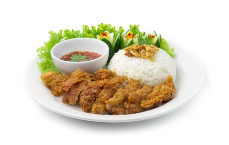 Fried Chicken With Rice on top Crispy Garlic Asian Food fusion style decorate carved cucumber Served Sweet Chili Sauce Thai Food Style side viewの写真素材