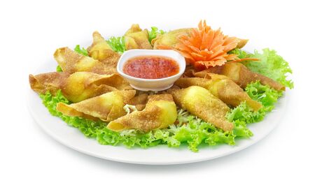 Crispy Wonton with Quail Egg Stuffed inside Served Sweet Chili dipping Sauce Appetizer Thai food Mix Chinese Food Asian style decorate with carved Chili peppers, vegetables side viewの写真素材