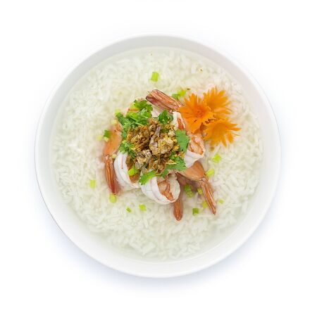 Rice Porridge boiled with Shrimps cooking tasty Main Course Thai food fusion style decorate mix Chinese food style decorate with carved carrots and vegetable cutlet,Crispy Garlic top viewの写真素材